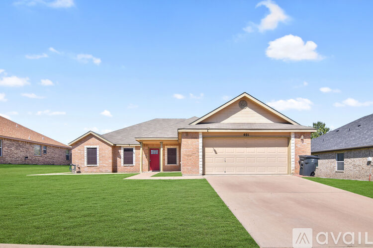 A house with a garage and a driveway in front.