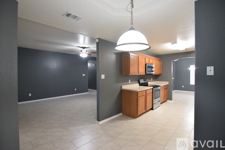 A kitchen area with a microwave, oven, and cabinets.