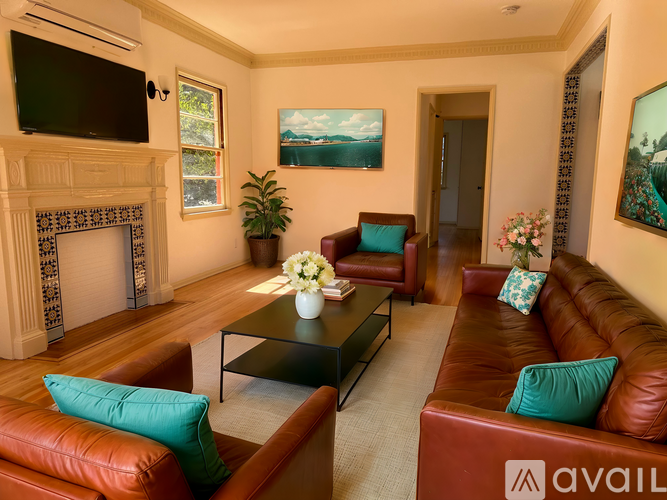 A living room with a fireplace, two couches, and a television.
