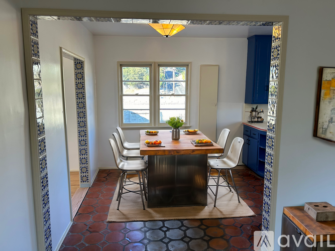 A dining room with a table set for four.