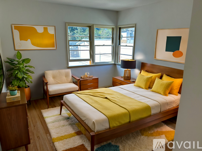 A bedroom with a bed, chair, and lamp.