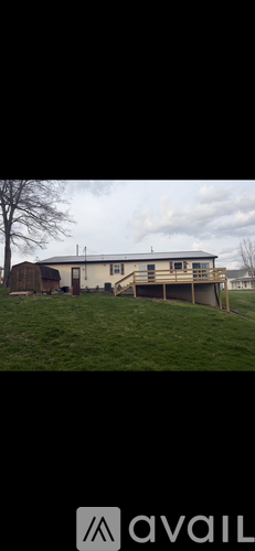 A grassy field with a building in the background.