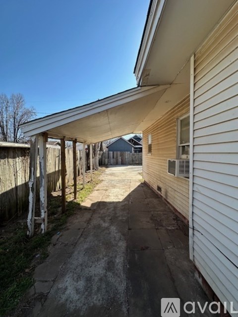 A long, narrow alley between two houses.