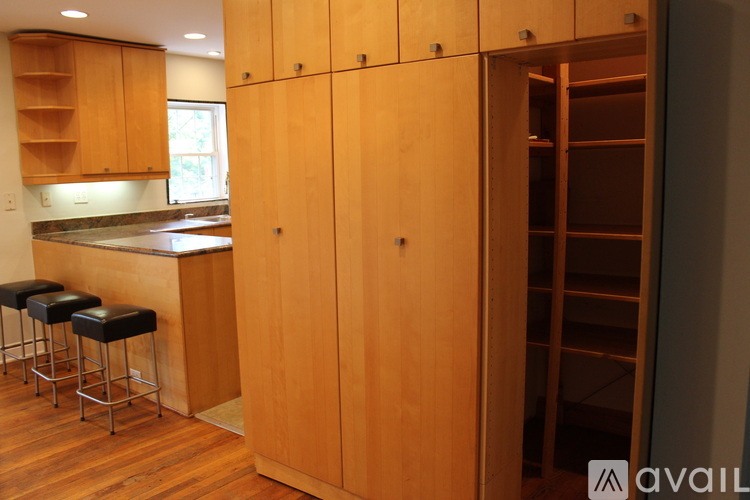 A kitchen with wooden cabinets and a bar area.
