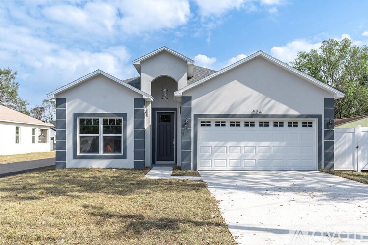 A two-story house with a garage is shown in the image.