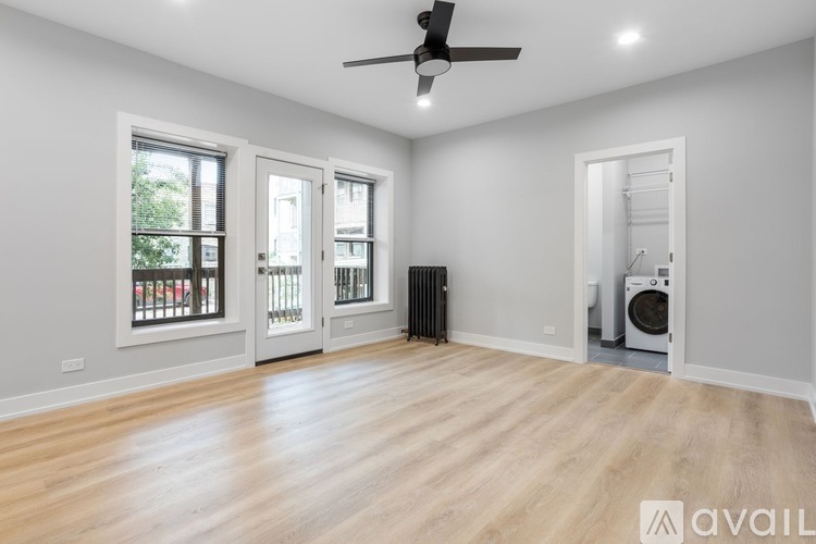 A spacious room with a washing machine in the corner.