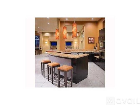 A kitchen with a bar area featuring a counter and stools.