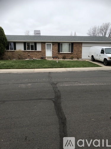 A white van is parked in front of a house.