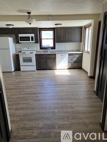 A kitchen with a white refrigerator and a stove top oven.