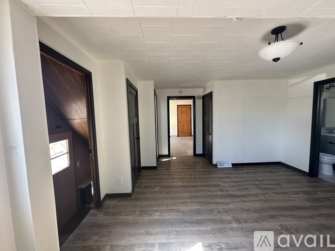 A house with a white exterior is for sale.
