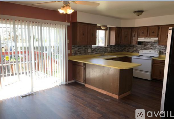 A kitchen with wooden cabinets and a yellow counter.