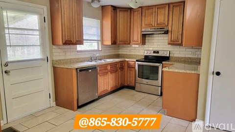 A kitchen with wooden cabinets and a phone number displayed on the image.