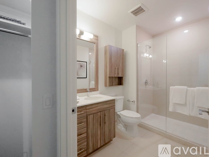 A bathroom with a toilet, sink, and shower.