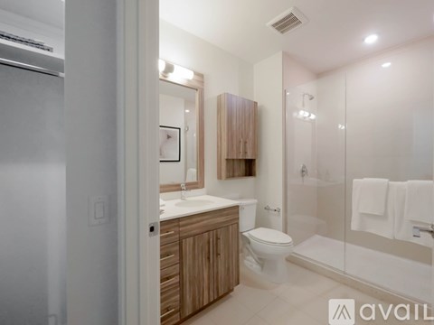 A bathroom with a toilet, sink, and shower.
