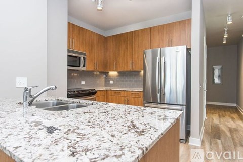 A kitchen with granite countertops and stainless steel appliances.