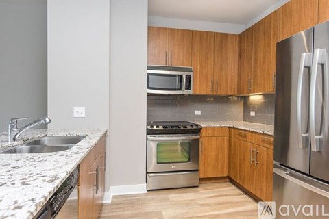A kitchen with wooden cabinets and stainless steel appliances.