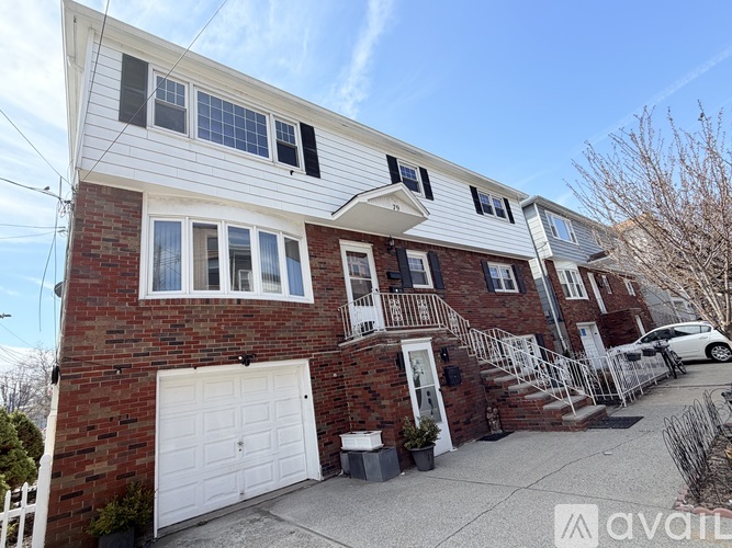 A row of houses with the first one having a white garage door.
