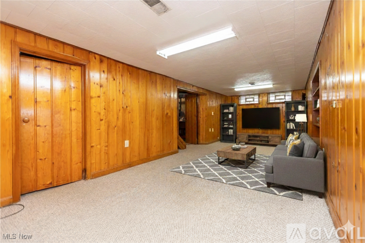 A living room with a grey couch and a coffee table.