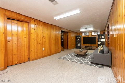 A living room with a grey couch and a coffee table.
