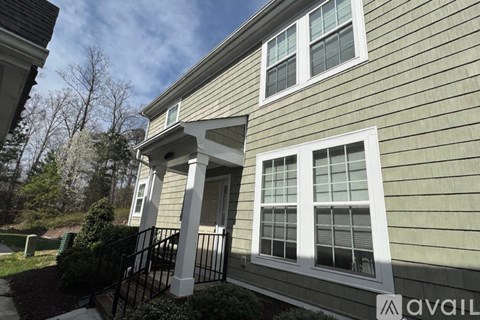 A house with a porch and a black railing.