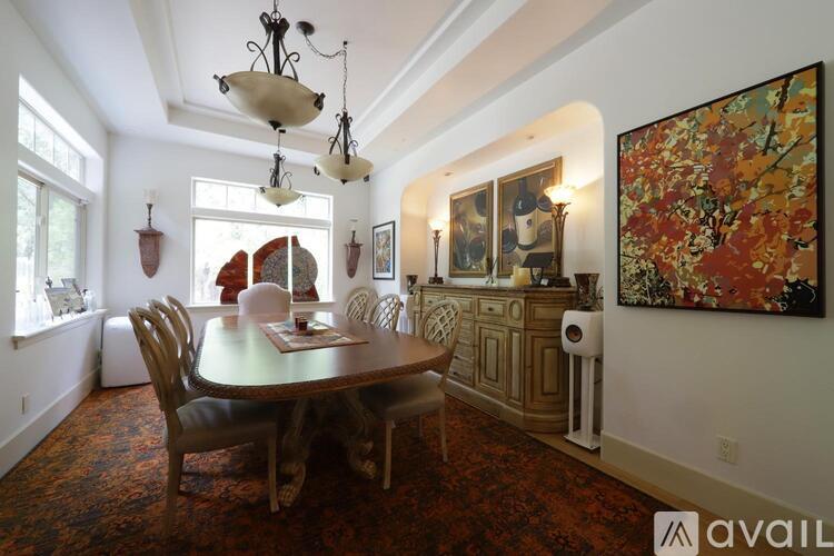 A dining room with a table and chairs.