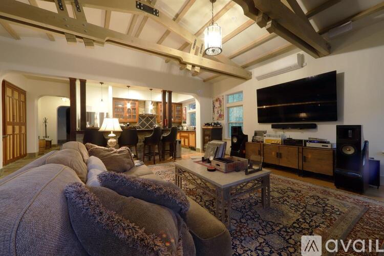 A living room with a grey sofa and a wooden coffee table.
