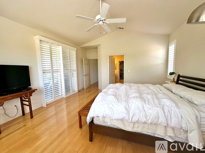 A bedroom with a large bed and a television.