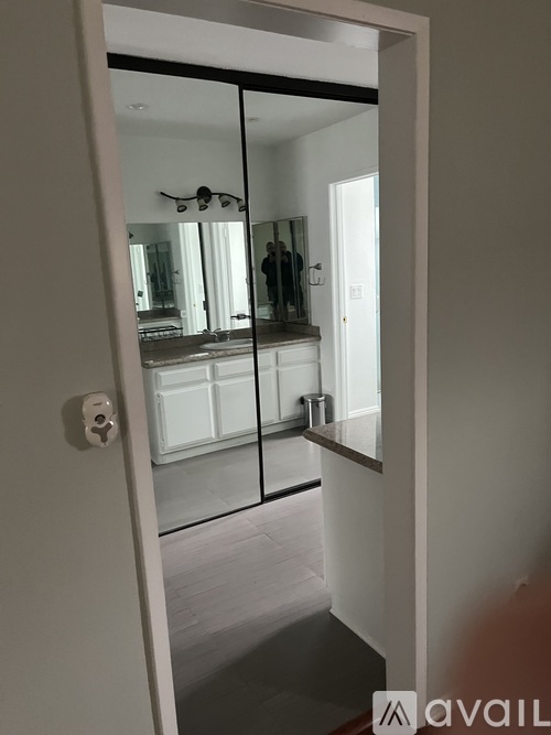 A mirrored doorway leading to a bedroom.