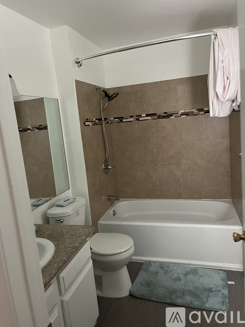 A bathroom with a toilet, sink, and bathtub.