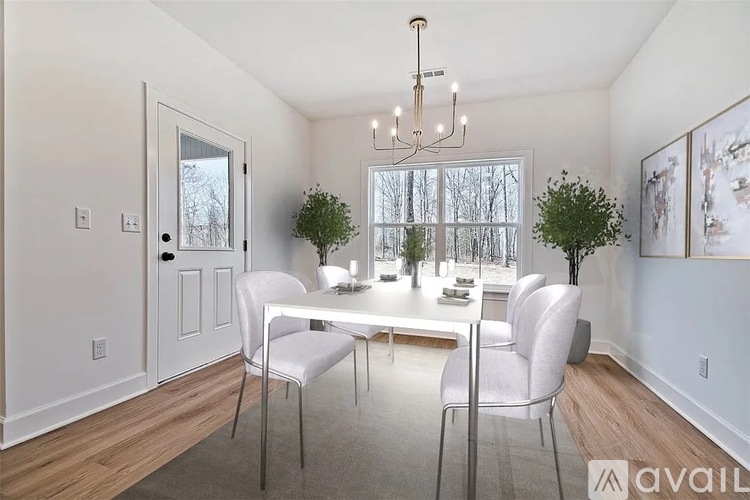 A dining room with a table and chairs.