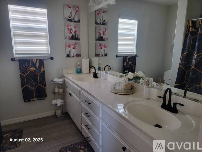 A bathroom with a white sink and a mirror above it.