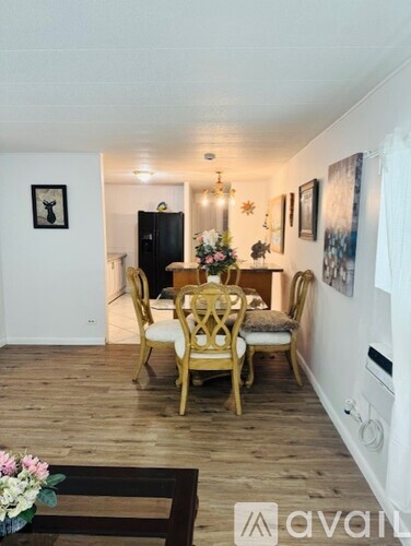 A dining room with a wooden table and chairs.