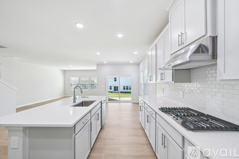 A modern kitchen with white cabinets and a large island.