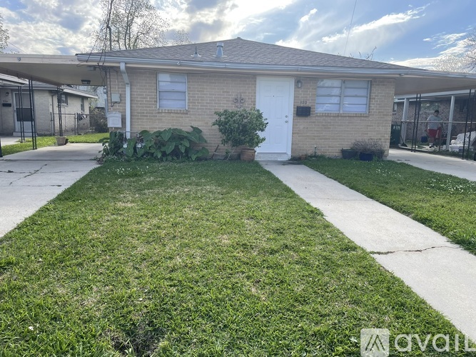 A house with a white door and a small front yard.