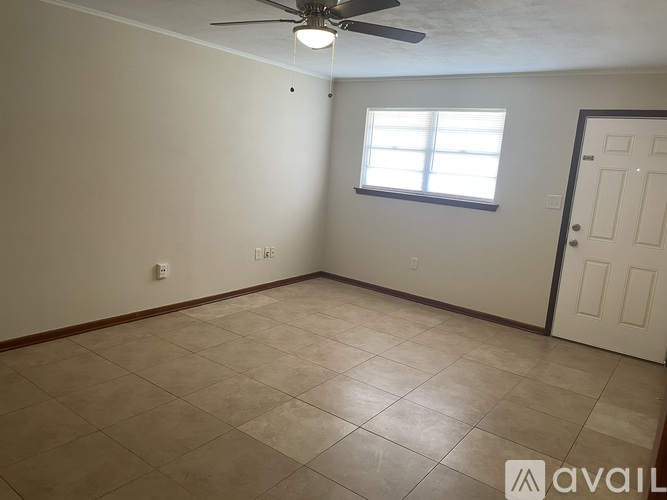 A room with a ceiling fan and a window.