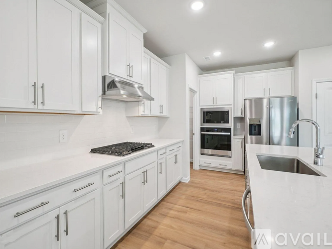 A kitchen with white cabinets and stainless steel appliances.