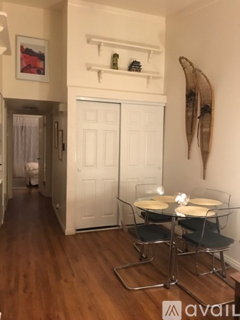 A dining room with a glass table and chairs.