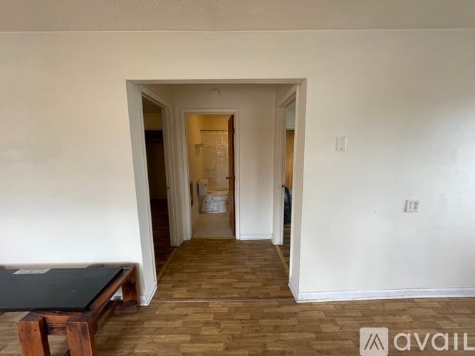 A room with a wooden floor and a table in it.