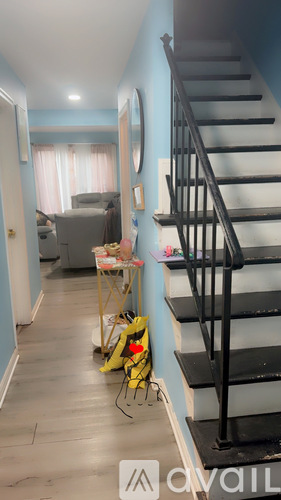 A staircase with a yellow bag on the floor.