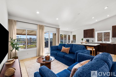 A living room with blue sofas and a coffee table.