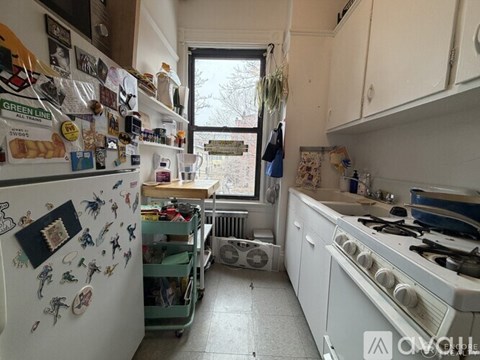 A kitchen with white appliances and a white refrigerator covered in magnets.