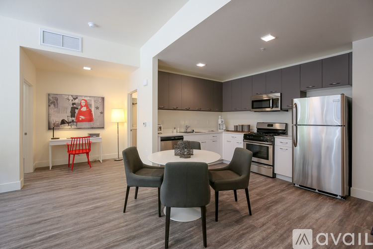 A modern kitchen with a dining table and chairs.