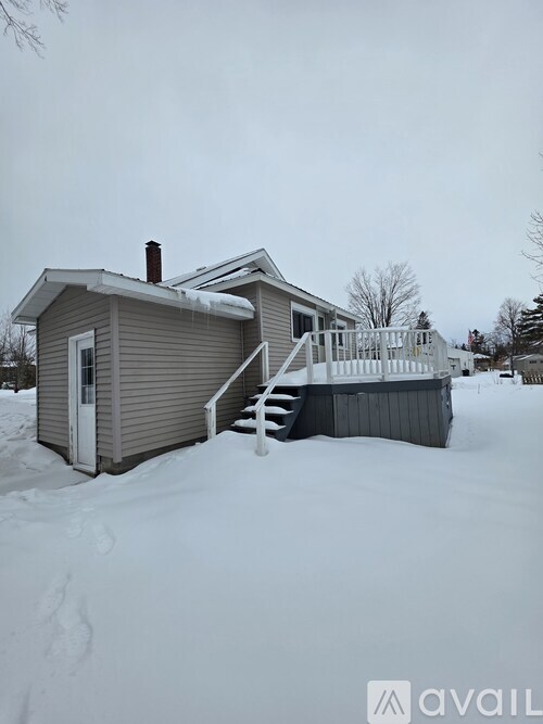 A house with a snow-covered front yard.