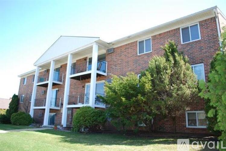 A red brick building with white trim and balconies.
