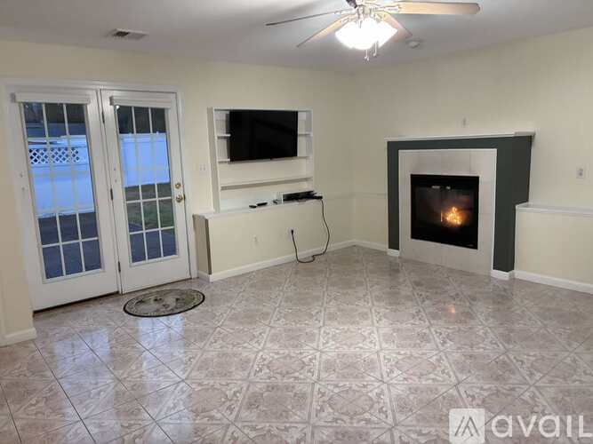 A living room with a fireplace and a television.