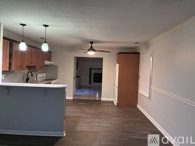 A kitchen with a counter and cabinets is available for rent.