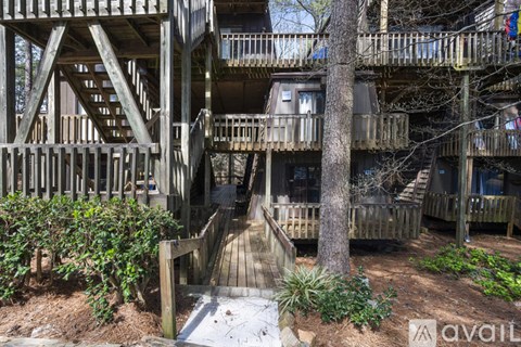 A wooden staircase leads up to a balcony.