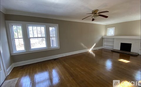 A room with a fireplace and a ceiling fan.