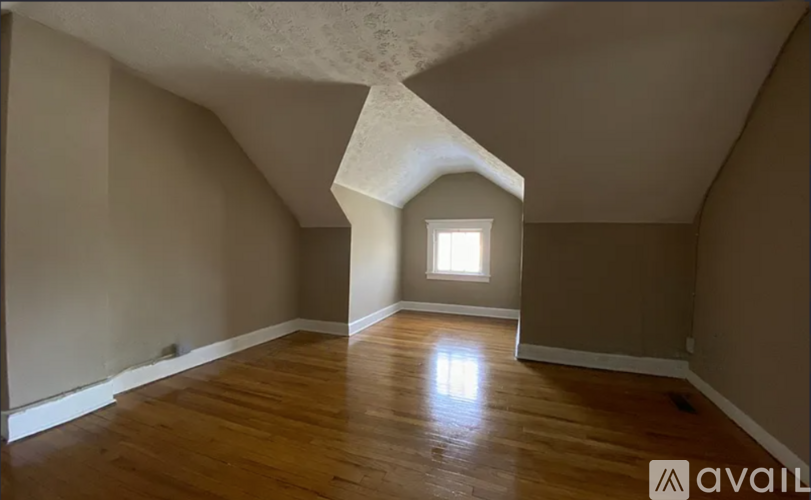 A room with wooden floors and a window.