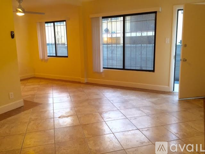 A room with tiled flooring and a sliding glass door.